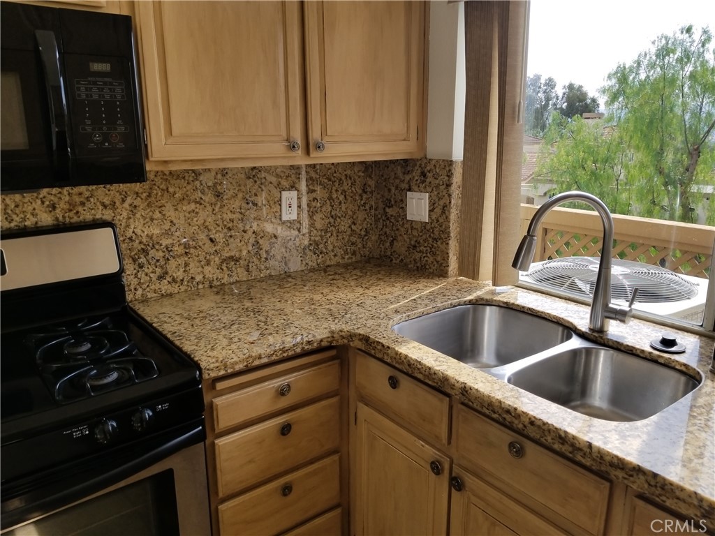 28225 Via Fierro Laguna Niguel, CA 92677 - Photo 15 of 70 a kitchen with sink a stove and cabinets