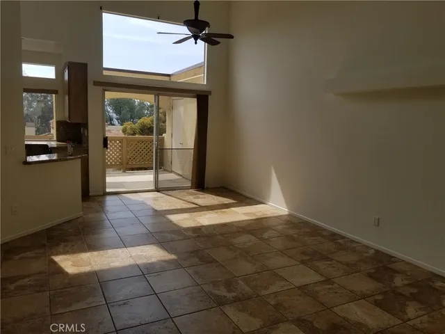 a view of a hallway with wooden floor and a living room