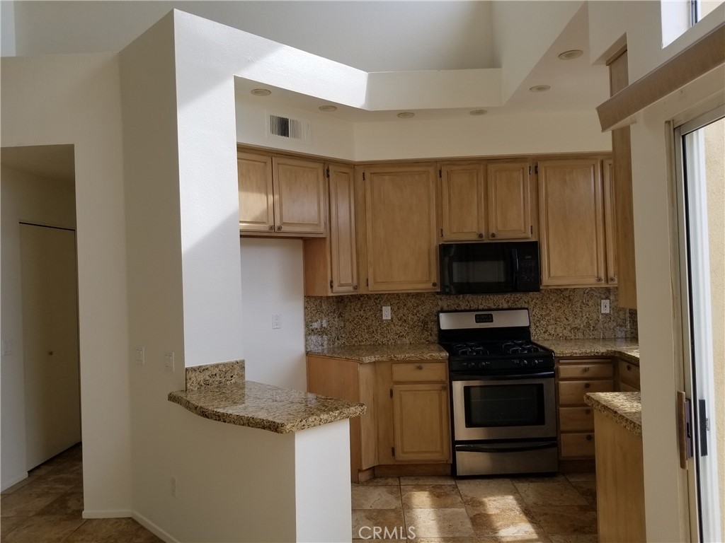28225 Via Fierro Laguna Niguel, CA 92677 - Photo 34 of 70 a kitchen with granite countertop a sink and steel appliances