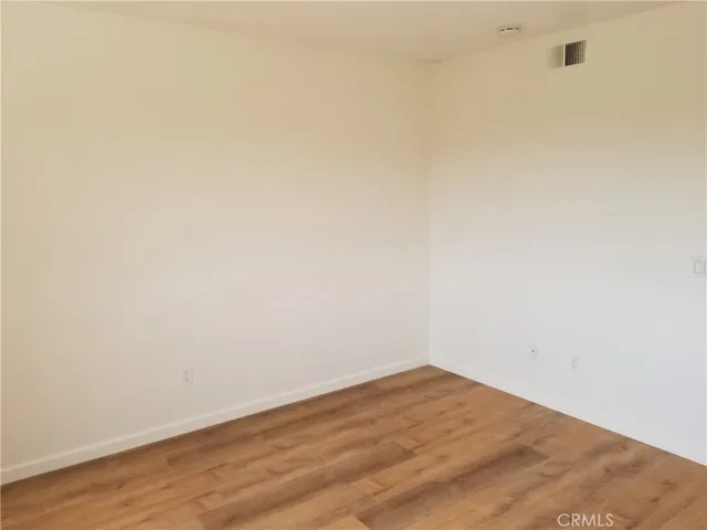 a view of a room with wooden floor and sliding door