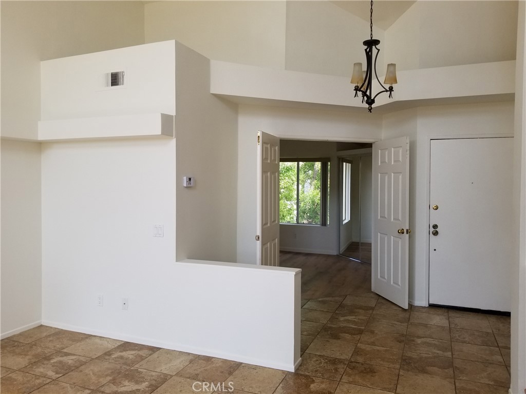 28225 Via Fierro Laguna Niguel, CA 92677 - Photo 59 of 70 a view of a hallway with chandelier and entryway