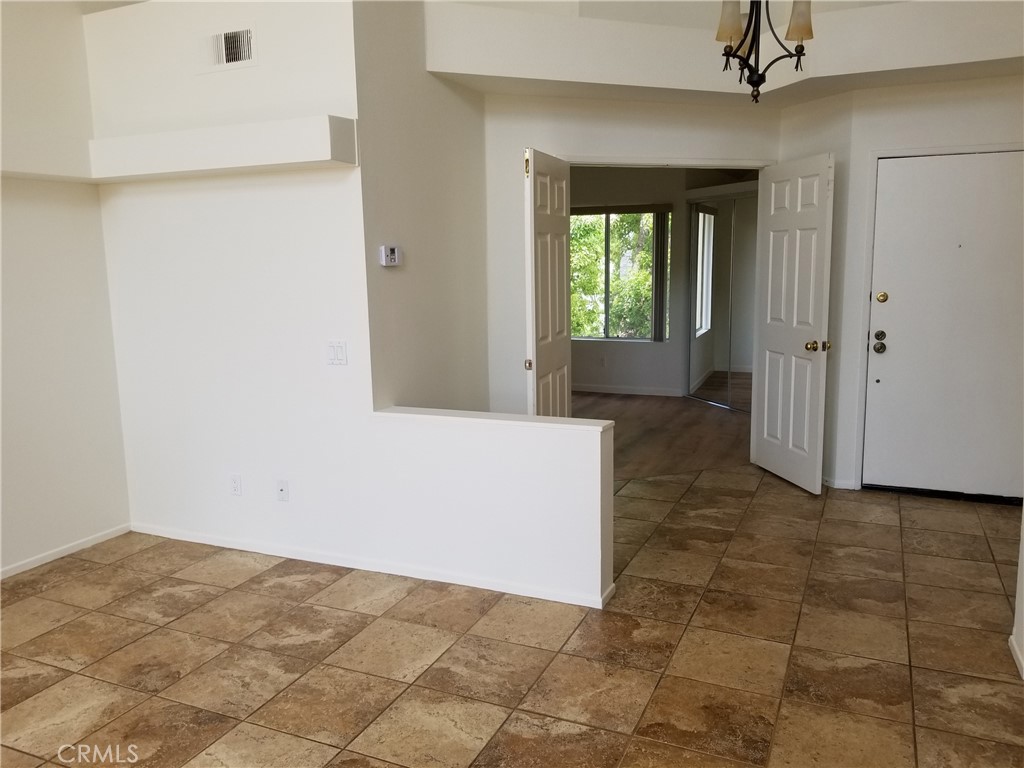 28225 Via Fierro Laguna Niguel, CA 92677 - Photo 6 of 70 a view of a hallway with wooden floor and a living room