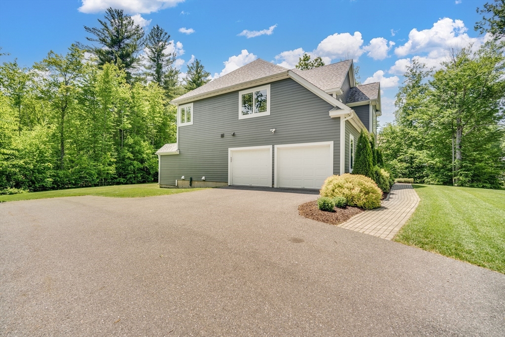 2 Nikkis Way Hadley, MA 01035 - Photo 39 of 40 a front view of a house with a yard and garage