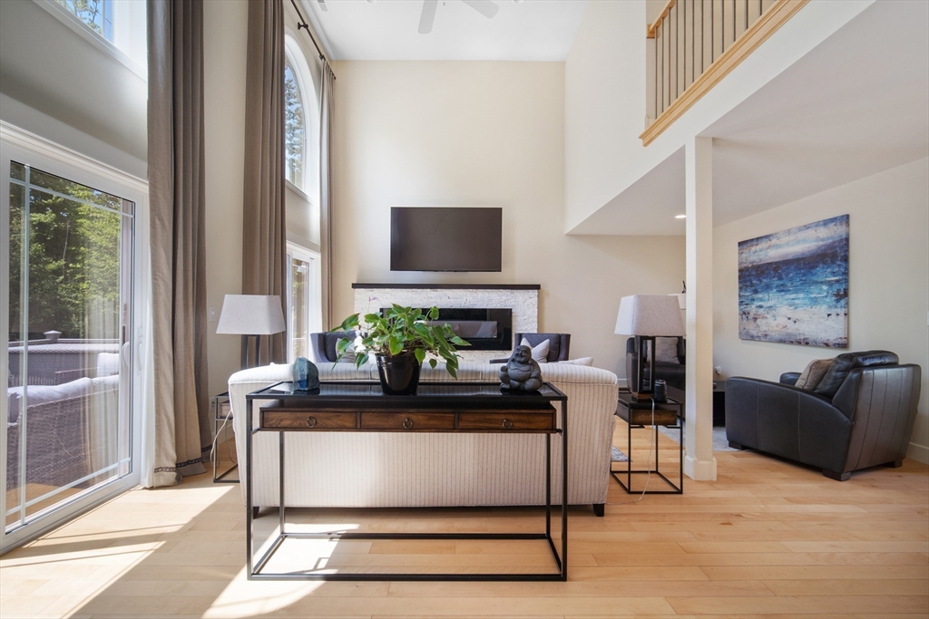 2 Nikkis Way Hadley, MA 01035 - Photo 8 of 40 a living room with furniture a flat screen tv and a floor to ceiling window