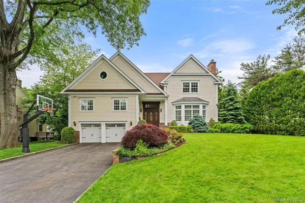 a front view of house with yard and green space