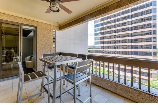 a balcony with table and chairs