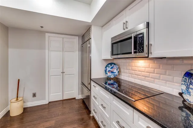 a kitchen with wooden cabinets and a stove top oven