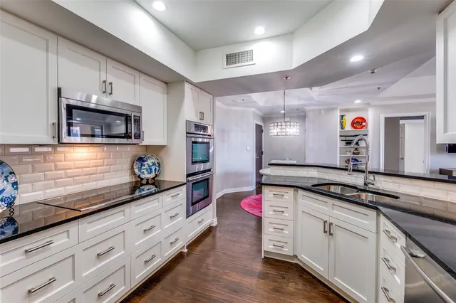 a kitchen with granite countertop a sink and cabinets