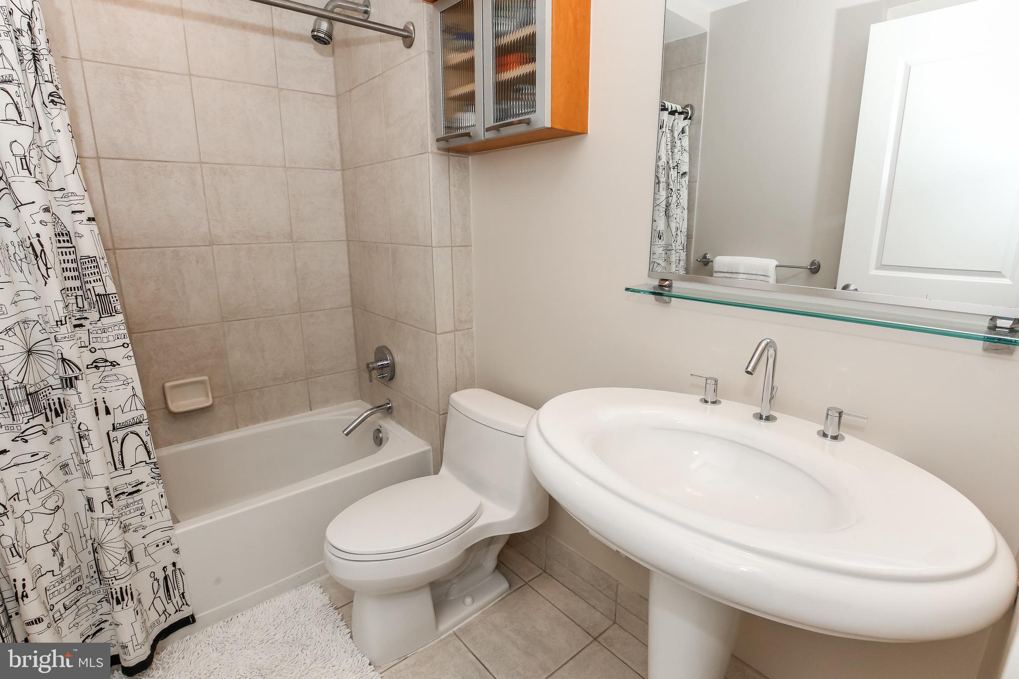 2421 18th Street Northwest, Unit 302 Washington, DC 20009 - Photo 15 of 30 a bathroom with a sink a toilet and a bathtub