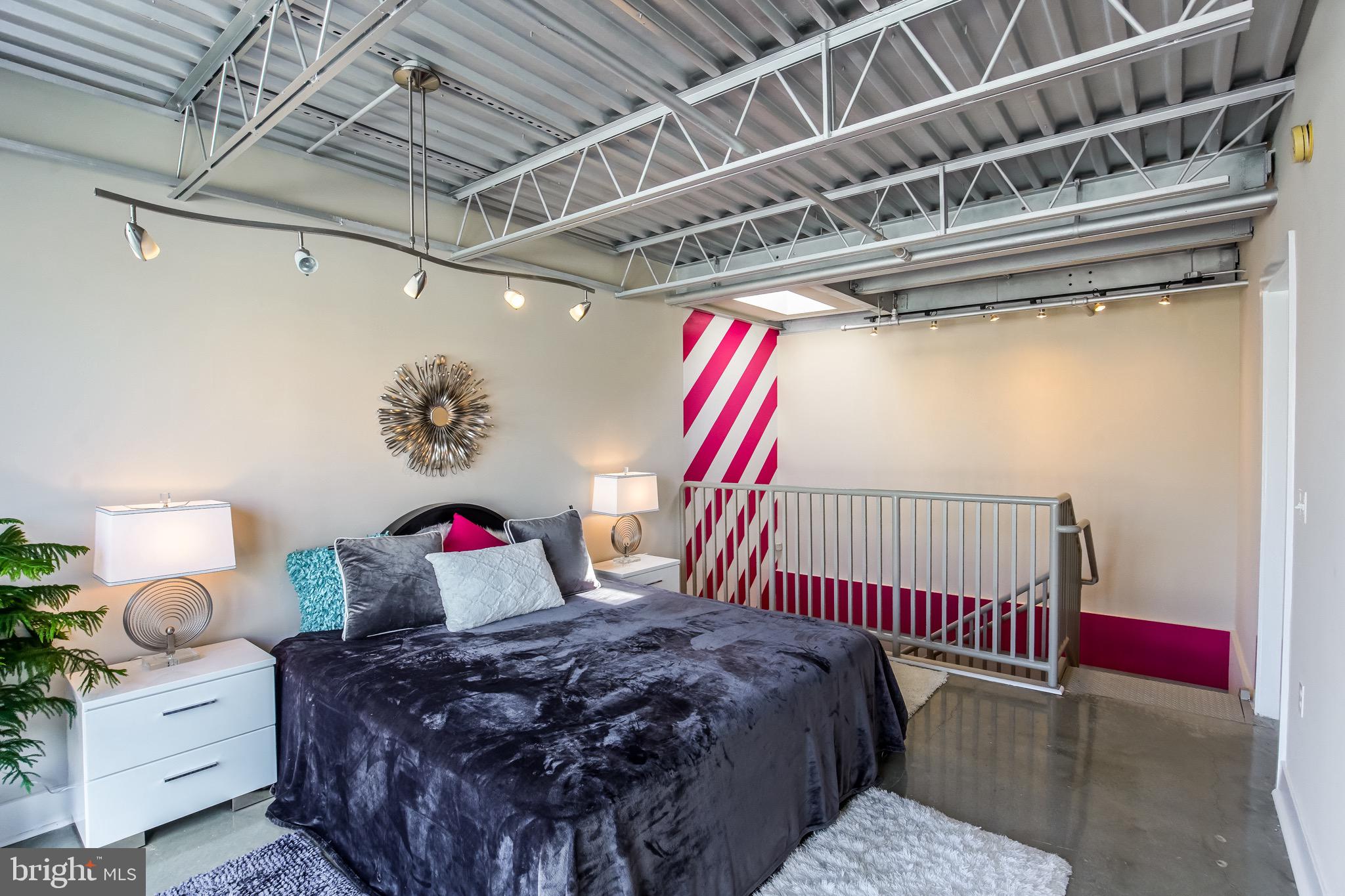 2421 18th Street Northwest, Unit 302 Washington, DC 20009 - Photo 19 of 30 a bedroom with a bed and a chandelier