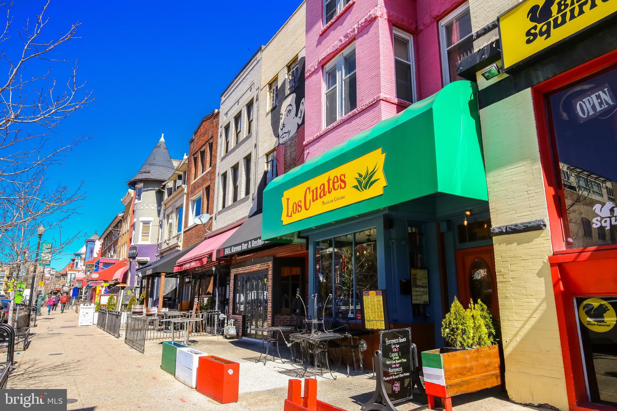 2421 18th Street Northwest, Unit 302 Washington, DC 20009 - Photo 30 of 30 a view of street with shops and fruits market