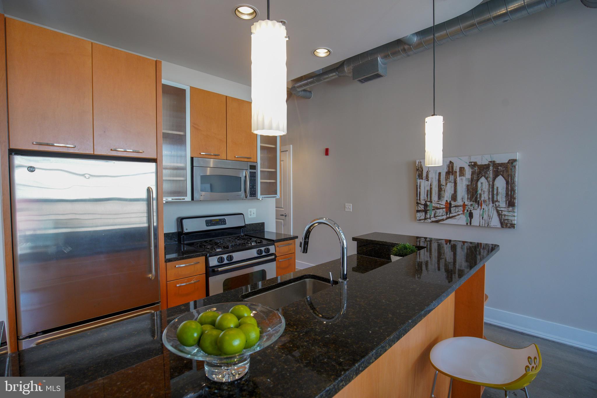 2421 18th Street Northwest, Unit 302 Washington, DC 20009 - Photo 6 of 30 a kitchen with sink refrigerator and stove