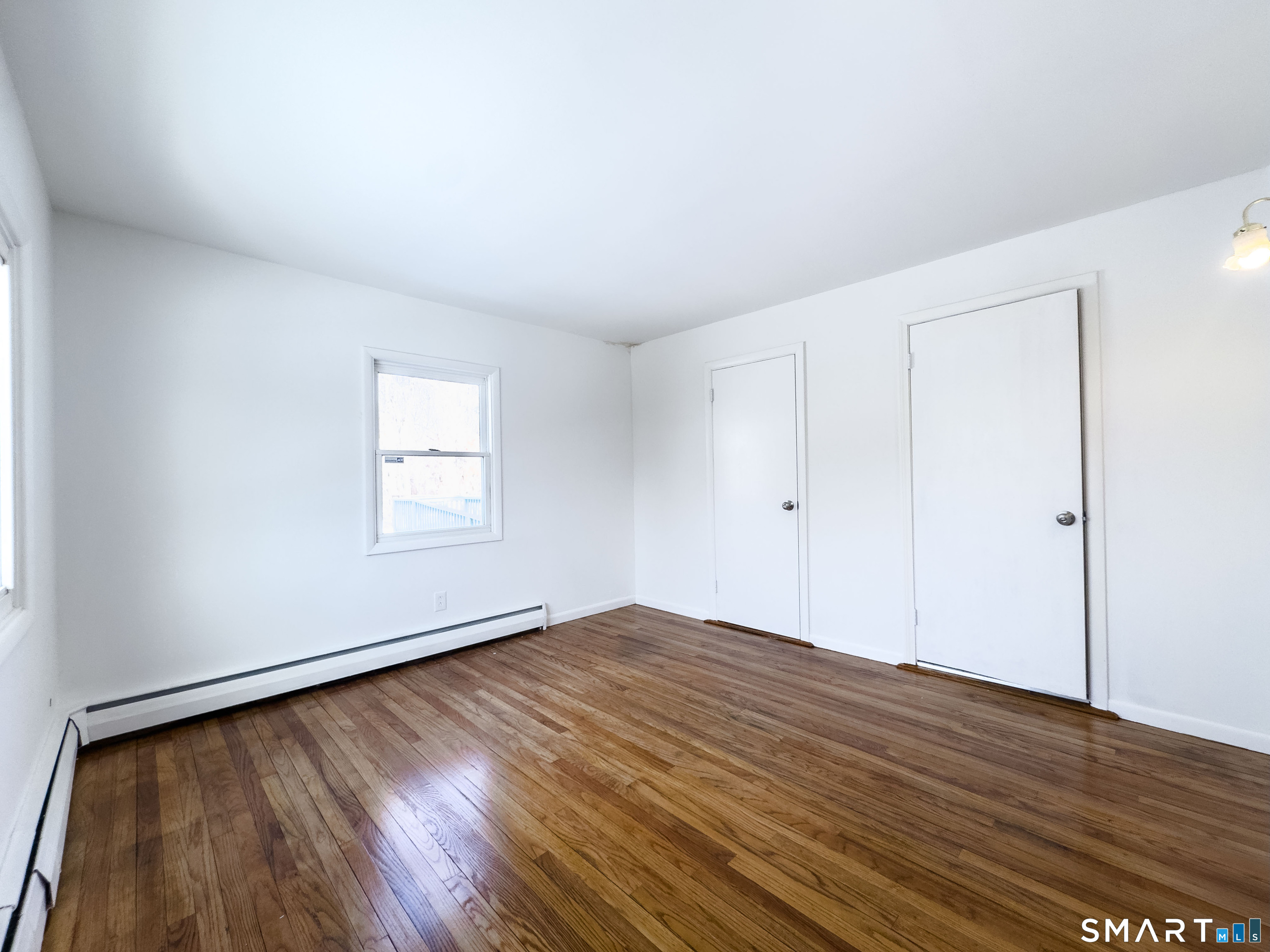 106 Augusta Street Watertown, CT 06779 - Photo 11 of 28 an empty room with wooden floor