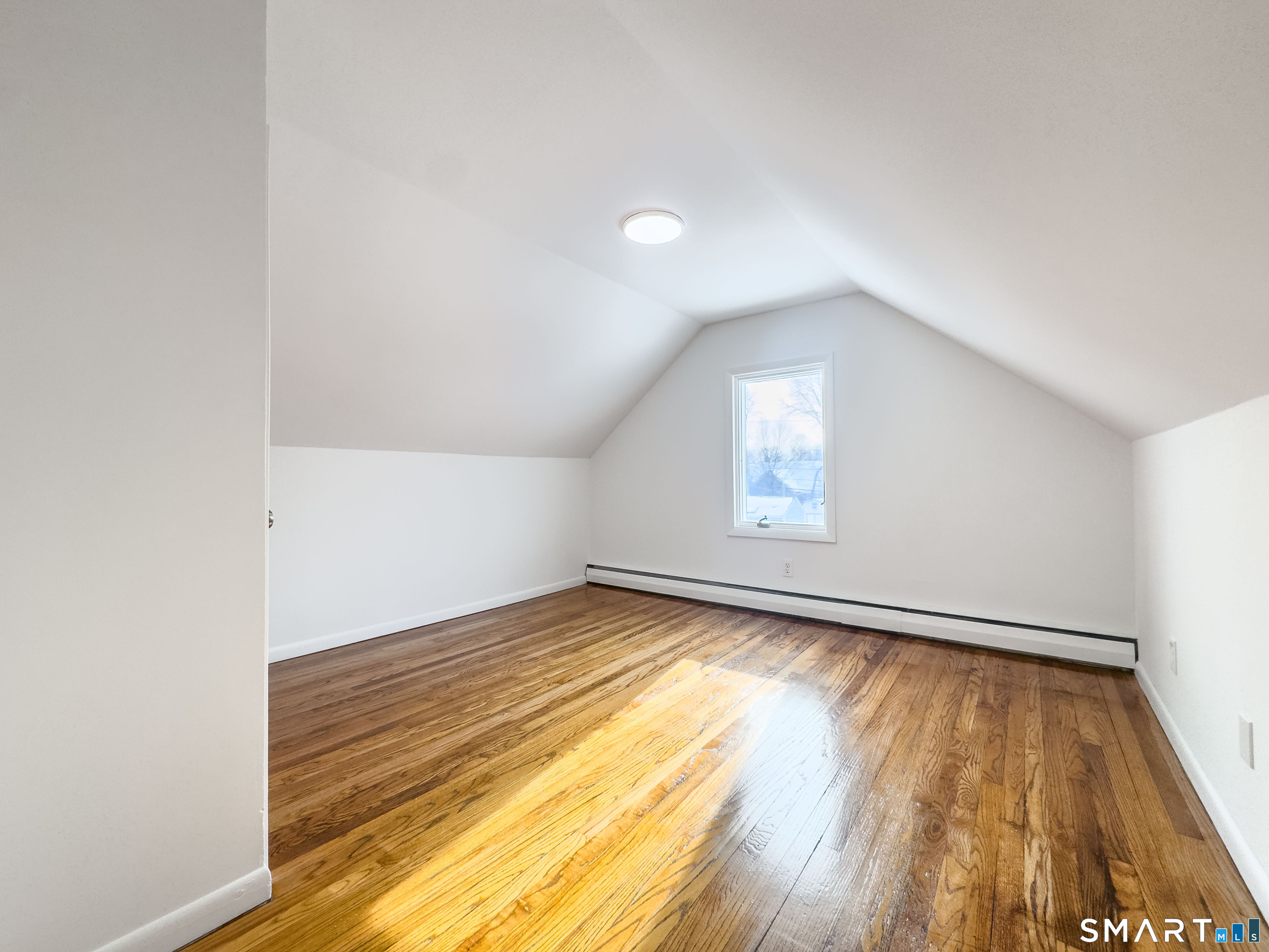 106 Augusta Street Watertown, CT 06779 - Photo 16 of 28 a view of empty room with wooden floor and fan