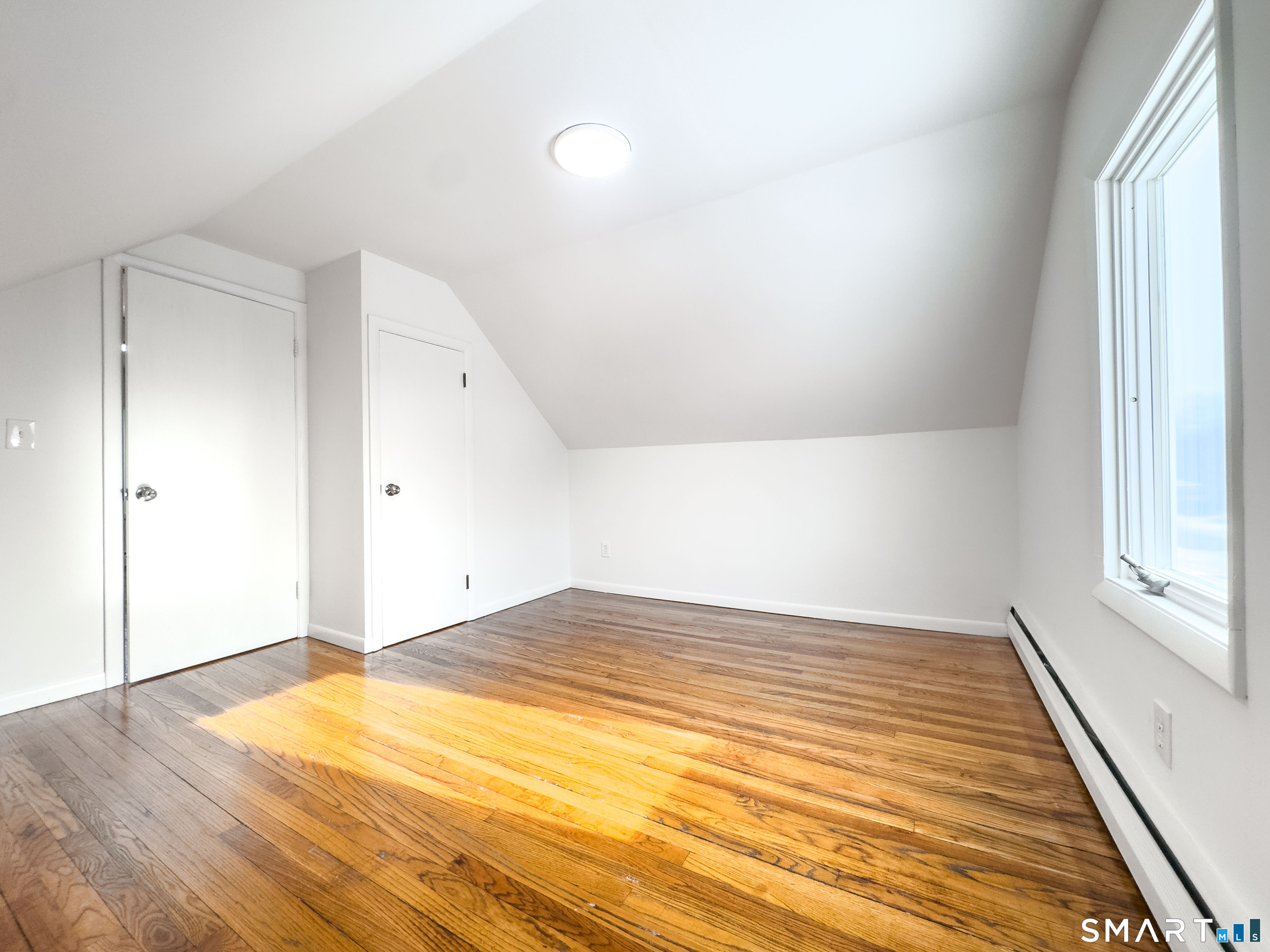 106 Augusta Street Watertown, CT 06779 - Photo 17 of 28 a view of empty room with wooden floor and fan