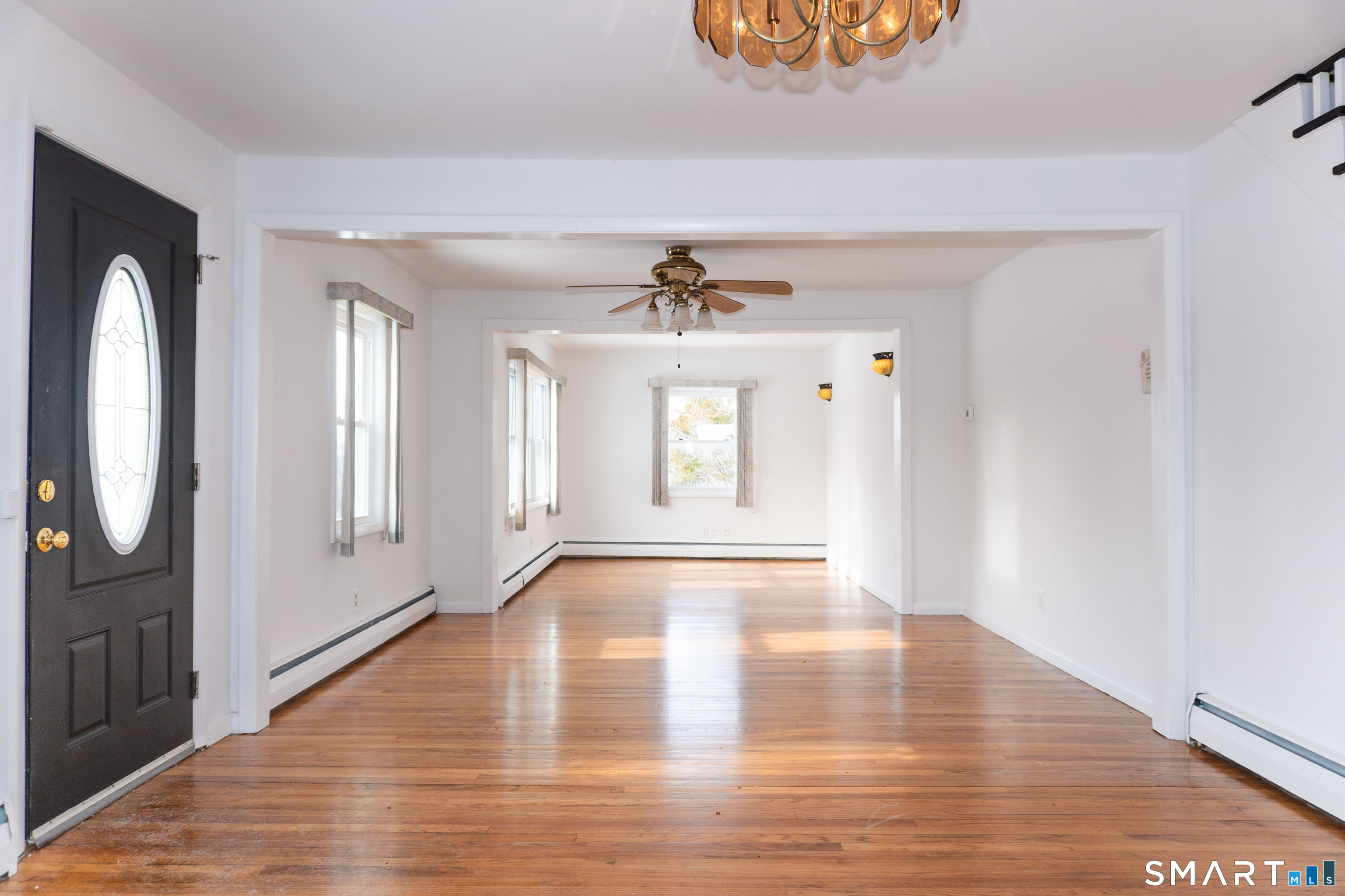106 Augusta Street Watertown, CT 06779 - Photo 5 of 28 a view of an empty room with wooden floor and a window