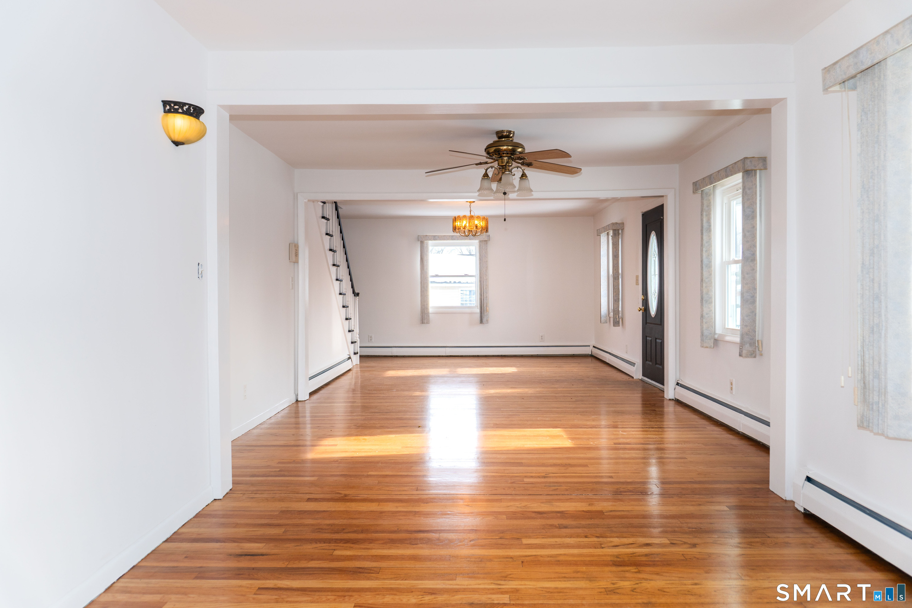 106 Augusta Street Watertown, CT 06779 - Photo 6 of 28 a view of an empty room with window and wooden floor