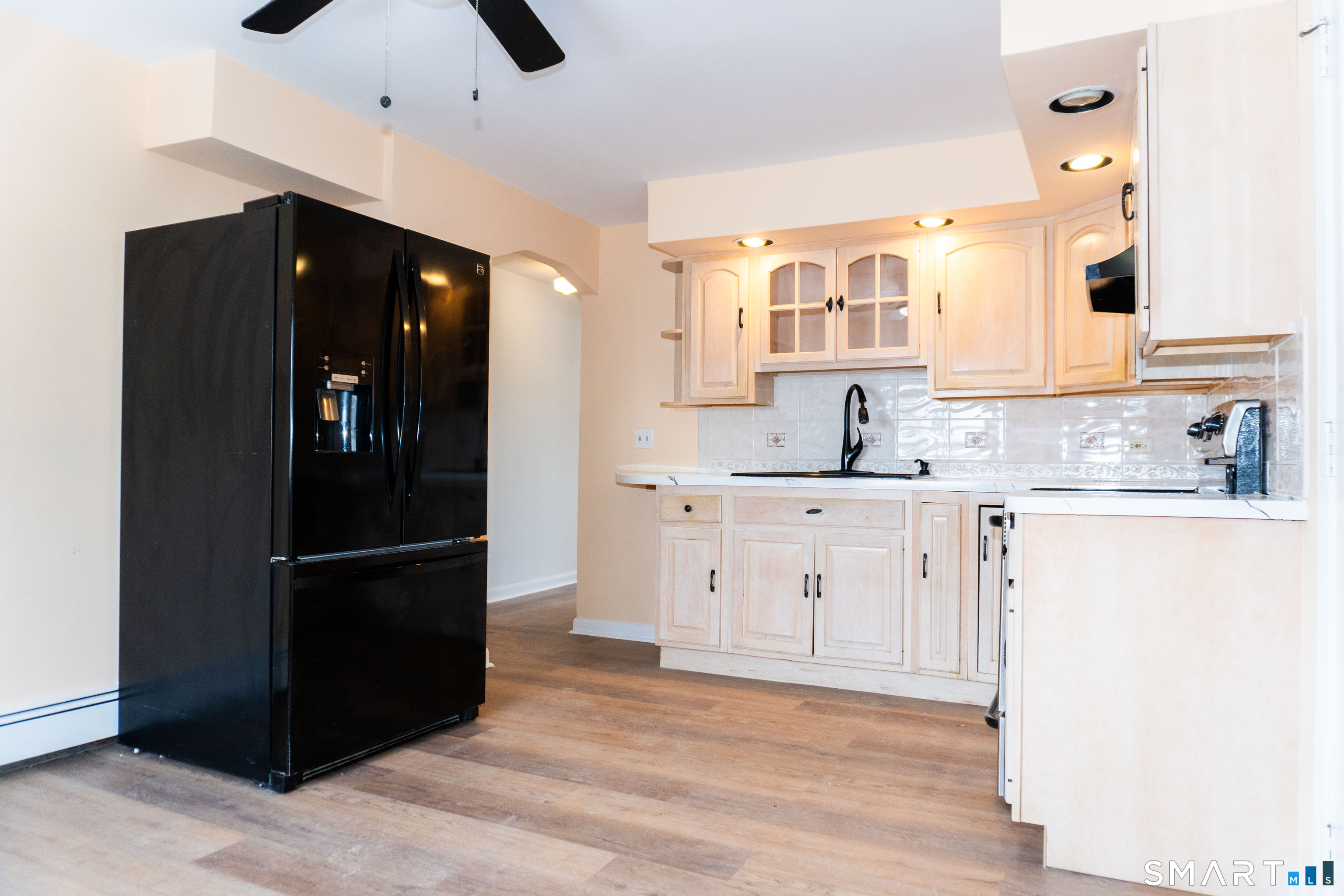 106 Augusta Street Watertown, CT 06779 - Photo 7 of 28 a kitchen with granite countertop a refrigerator and a sink