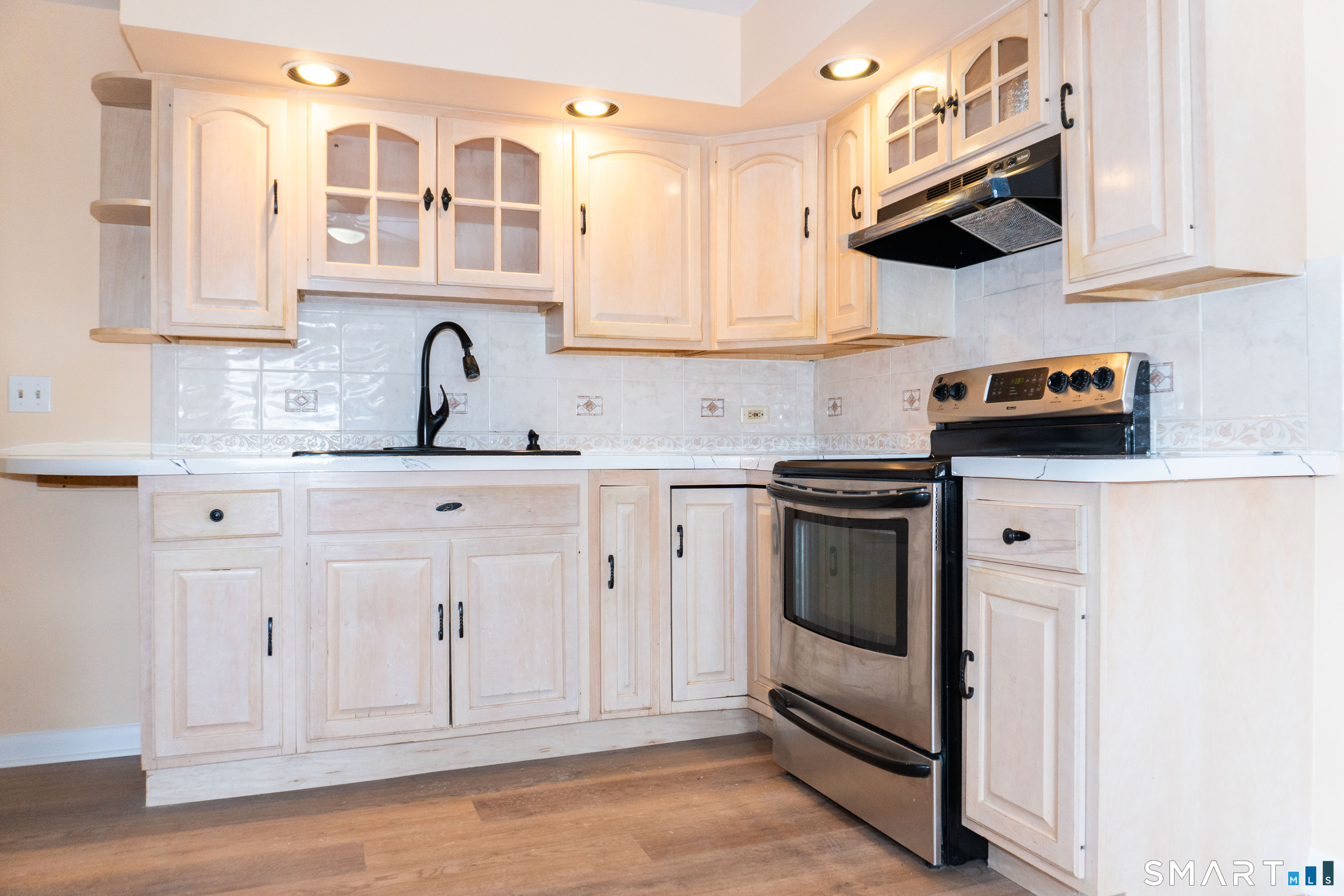 106 Augusta Street Watertown, CT 06779 - Photo 8 of 28 a kitchen with stainless steel appliances white cabinets and a sink