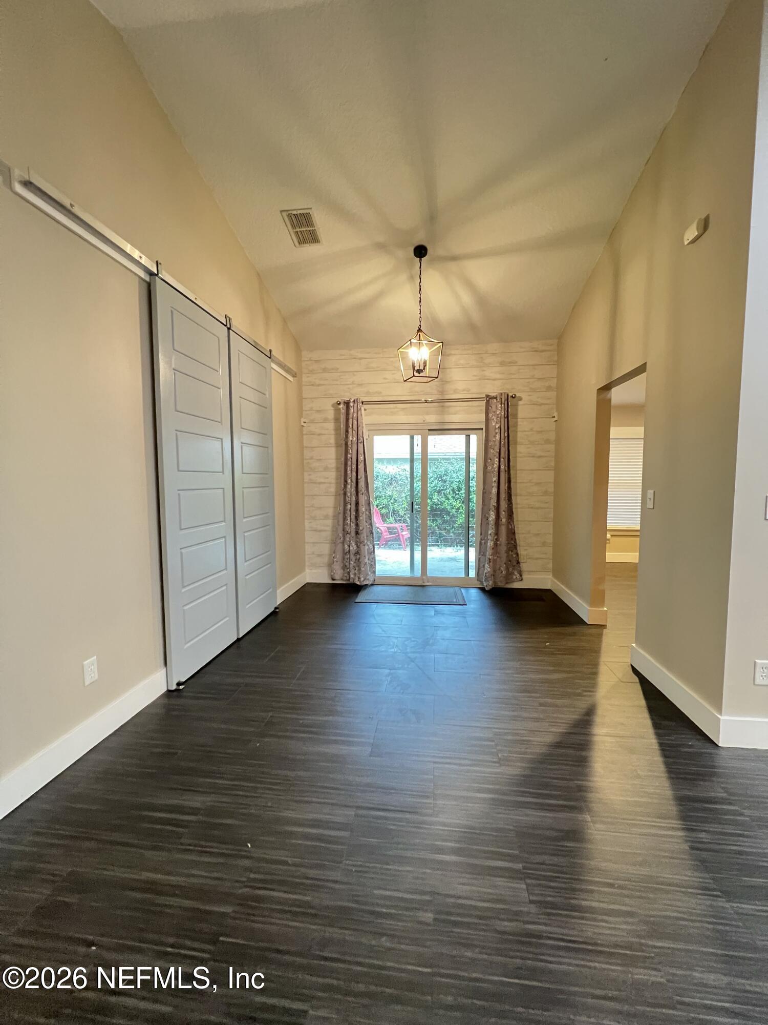 1115 Main Street Atlantic Beach, FL 32233 - Photo 3 of 14 an empty room with wooden floor and windows
