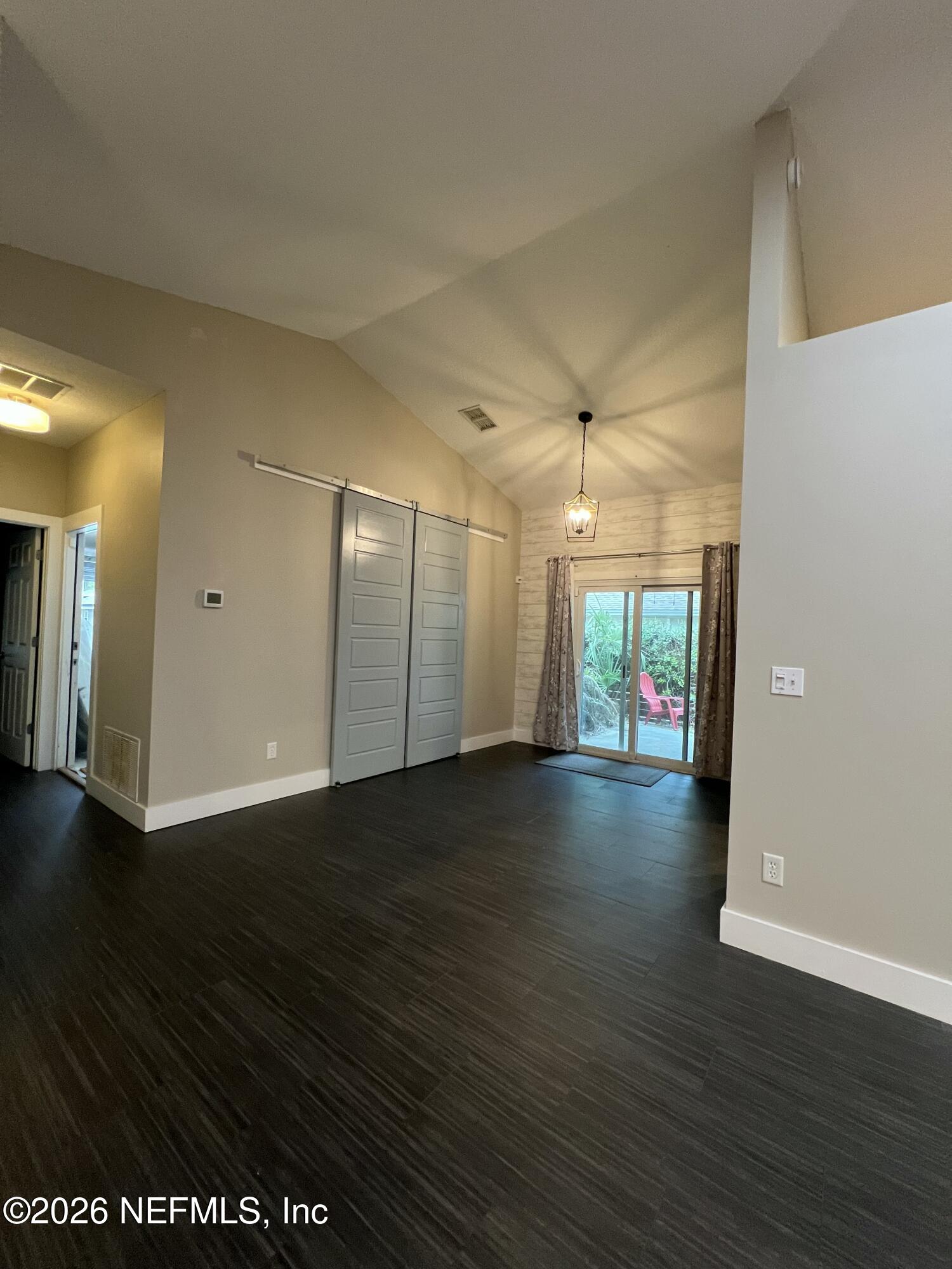 1115 Main Street Atlantic Beach, FL 32233 - Photo 4 of 14 an empty room with wooden floor and windows