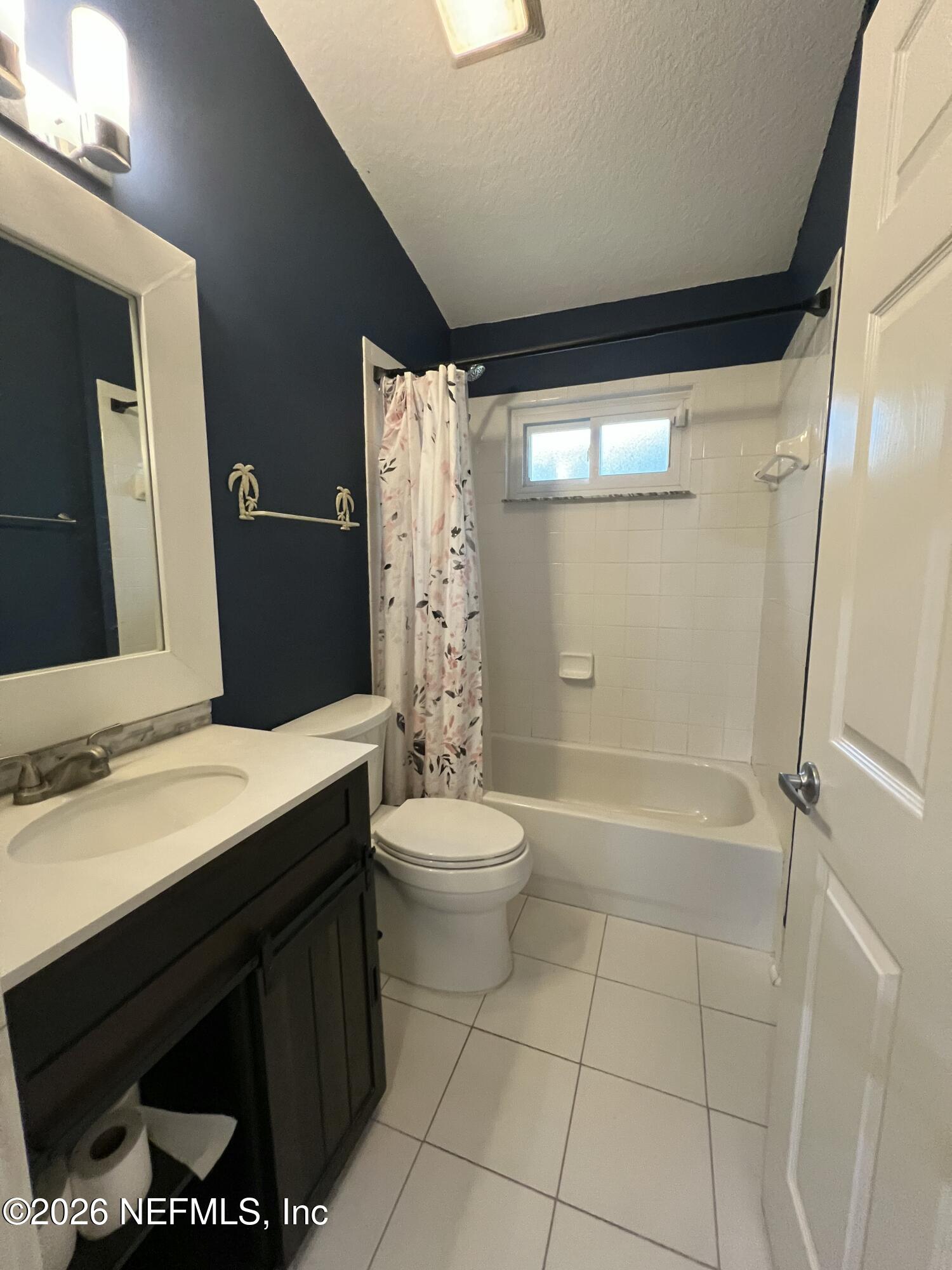 1115 Main Street Atlantic Beach, FL 32233 - Photo 7 of 14 a bathroom with a sink a toilet and shower