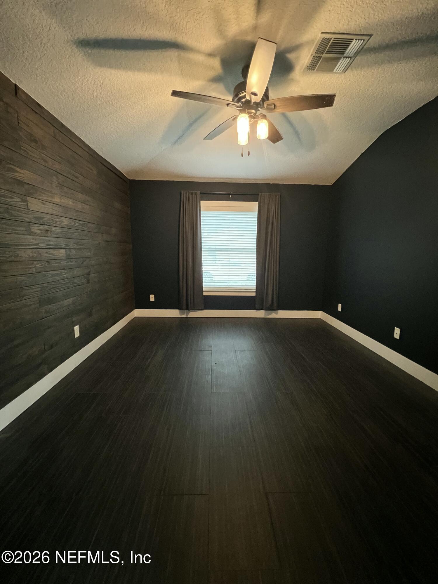1115 Main Street Atlantic Beach, FL 32233 - Photo 8 of 14 a view of an empty room with wooden floor and a window