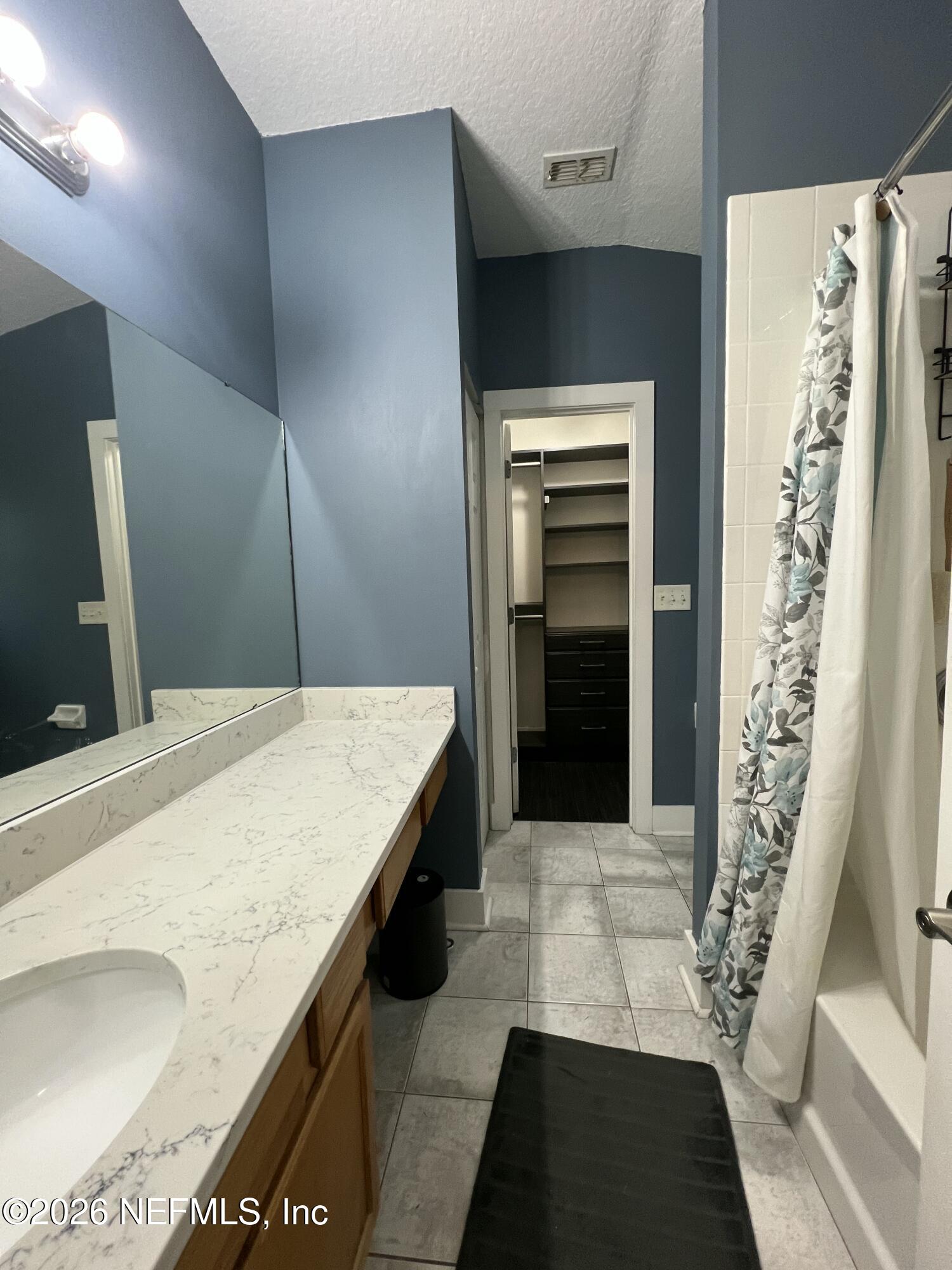 1115 Main Street Atlantic Beach, FL 32233 - Photo 9 of 14 a bathroom with a granite countertop sink and a mirror