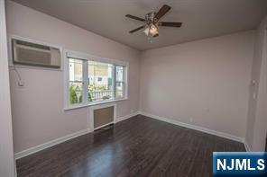 310 Union Street Carlstadt, NJ 07072 - Photo 6 of 24 an empty room with wooden floor and windows