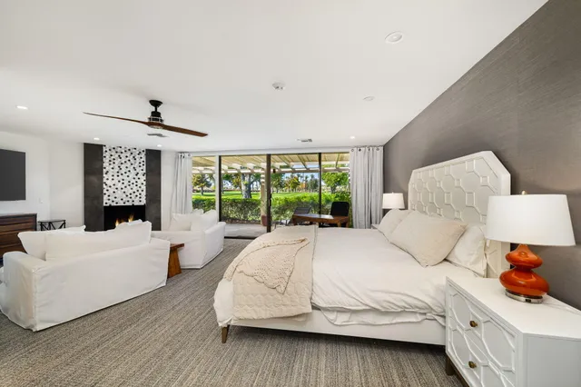 a bedroom with a bed and a large window