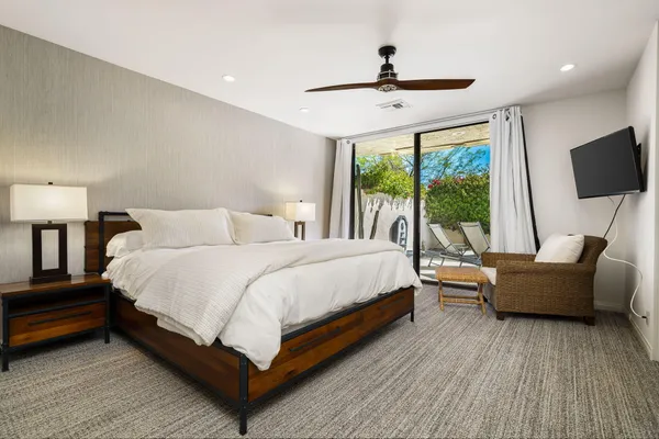 a bedroom with a bed and a large window