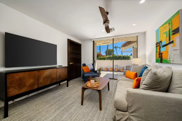 a outdoor living space with furniture and a flat screen tv