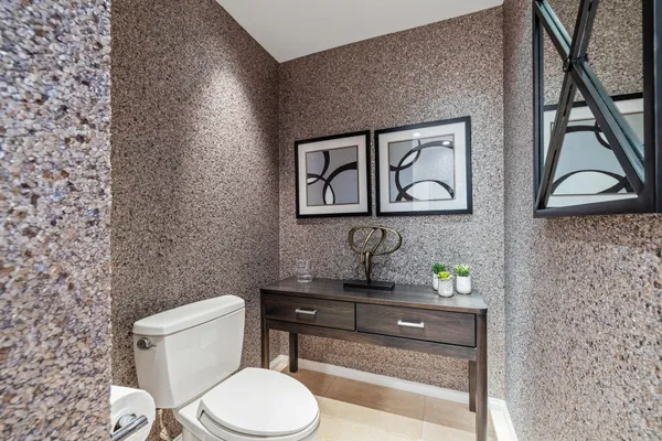 a bathroom with a toilet a sink and mirror