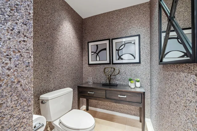 a bathroom with a toilet a sink and mirror