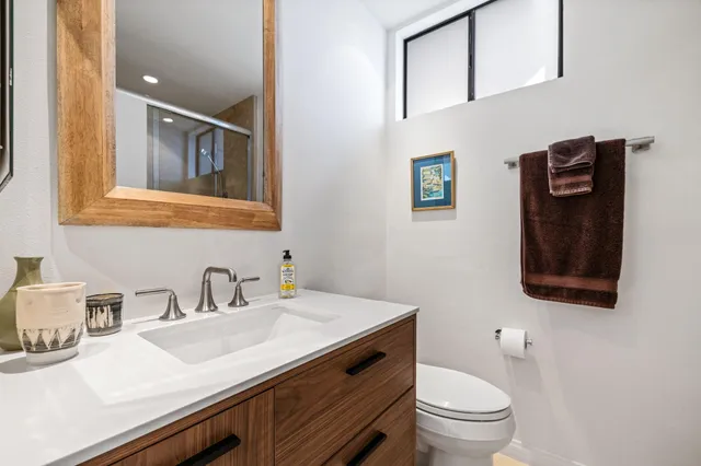 a bathroom with a sink vanity and toilet
