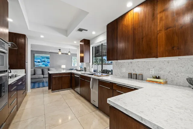 a kitchen with a sink a stove and cabinets