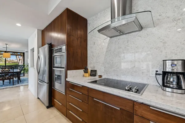 a kitchen with stainless steel appliances granite countertop a refrigerator and a sink