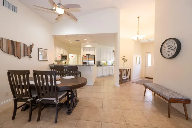 a view of a room with furniture and a chandelier