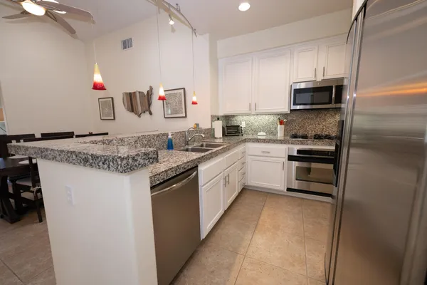 a kitchen with a sink stove and refrigerator