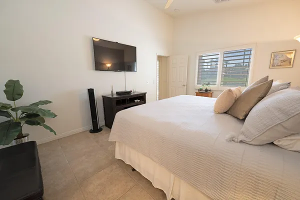 a bedroom with bed and a night stand