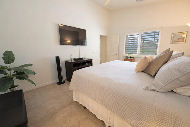 a bedroom with bed and a night stand