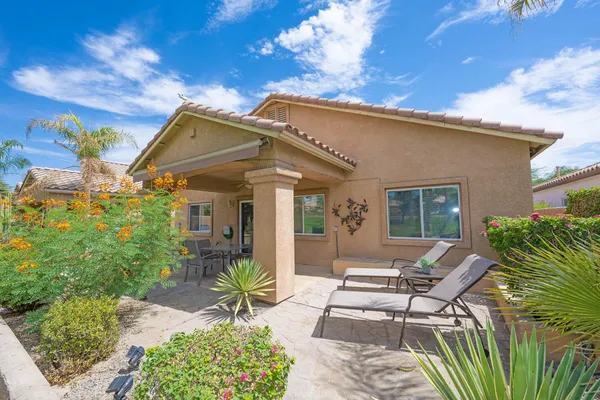 a view of a patio with table and chairs and potted plants