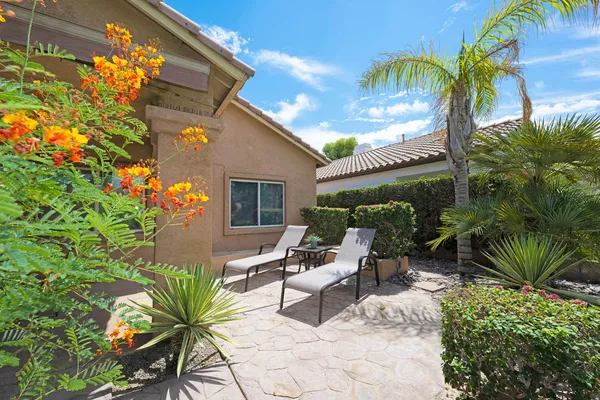 a view of a chairs and table in the patio