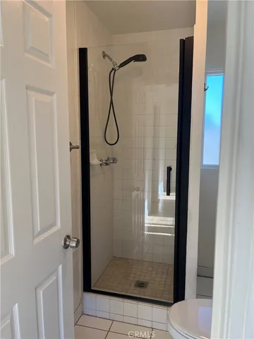 a bathroom with a glass shower door