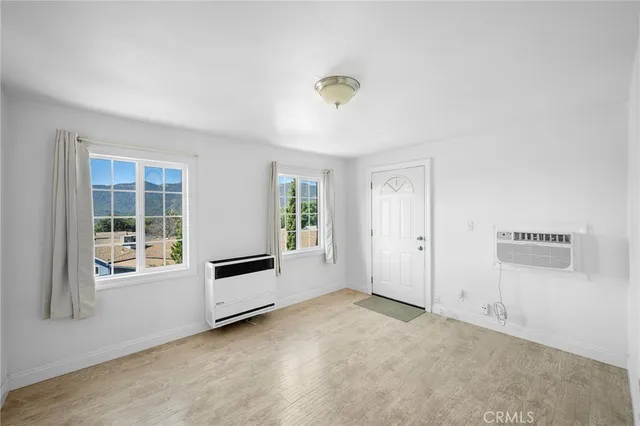 a view of a livingroom with an empty space and a window