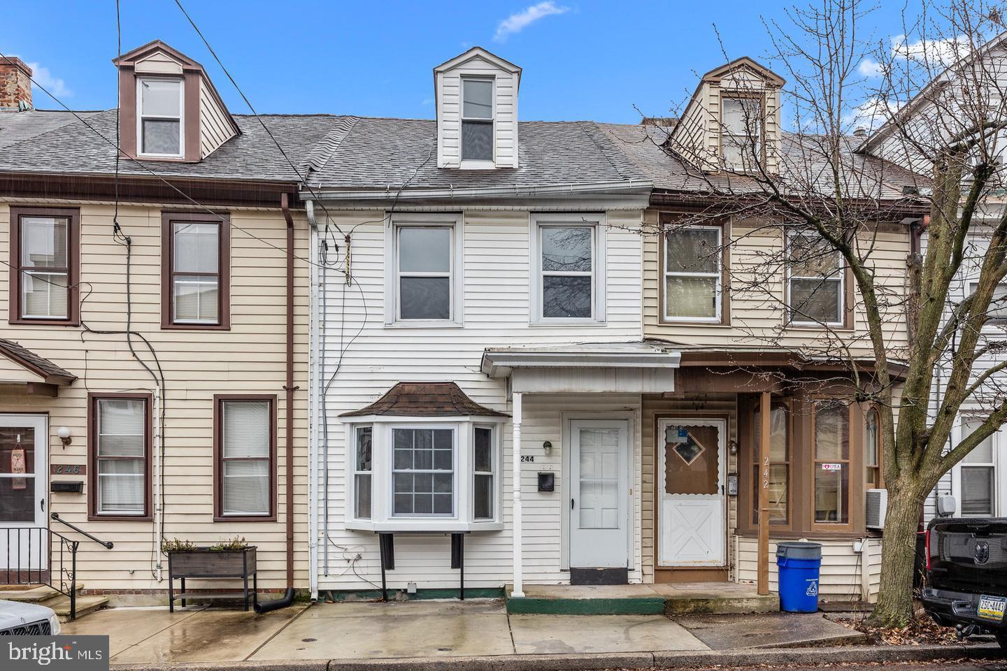 244 Cedar Street Bristol, PA 19007 - Photo 2 of 18 a front view of a residential apartment building with a yard