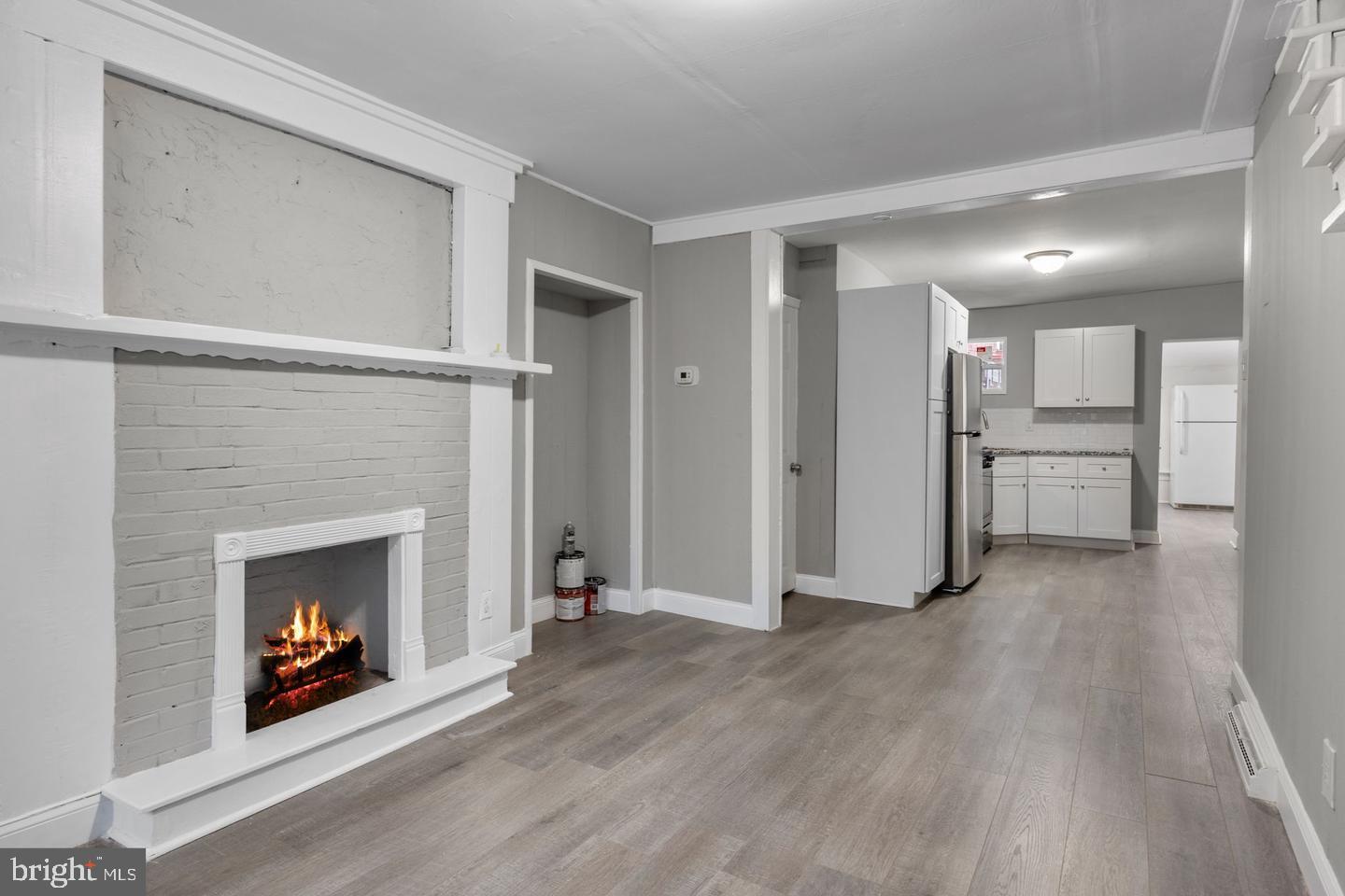 244 Cedar Street Bristol, PA 19007 - Photo 5 of 18 a view of a livingroom with a fireplace and window