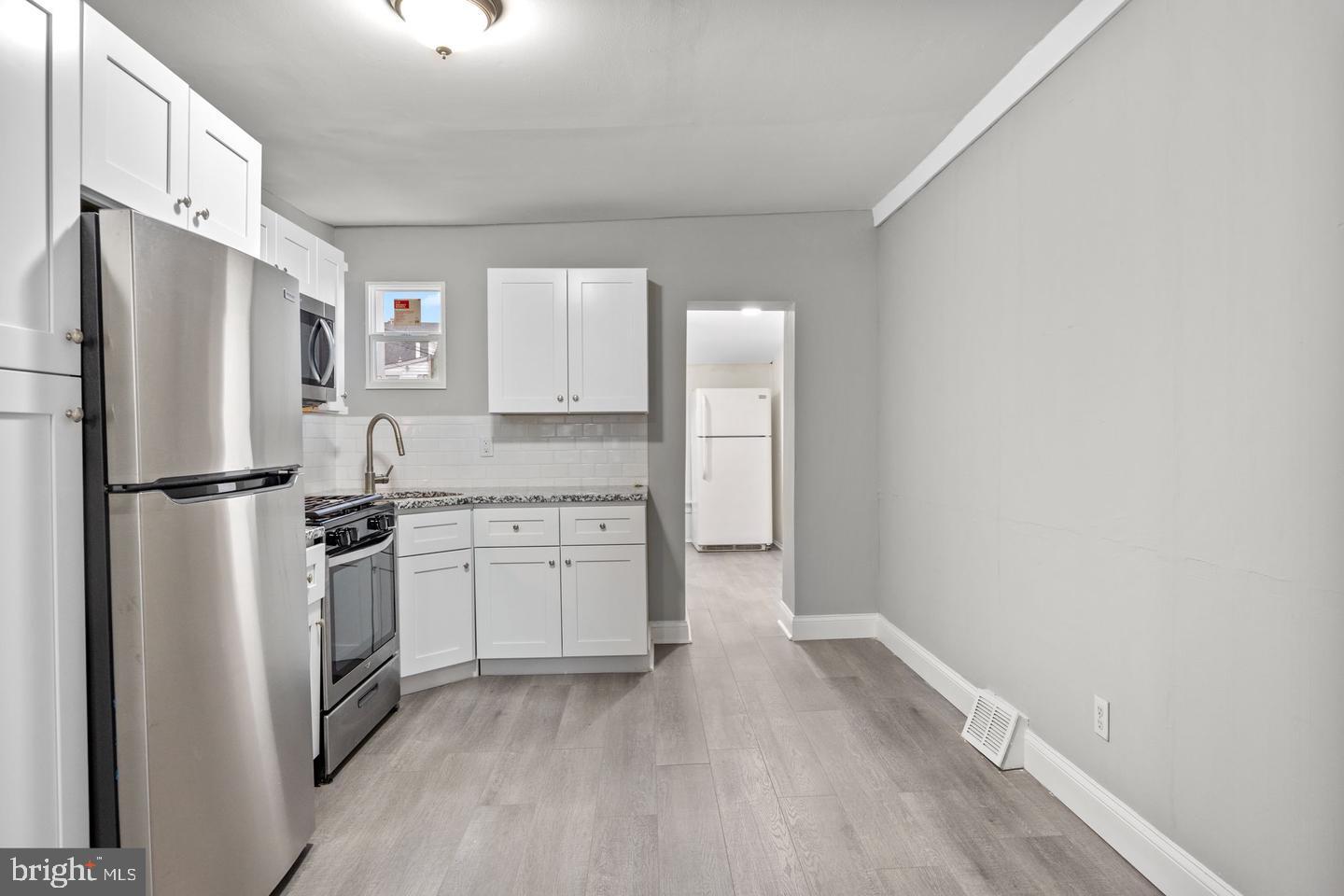 244 Cedar Street Bristol, PA 19007 - Photo 6 of 18 a kitchen with a refrigerator and a sink