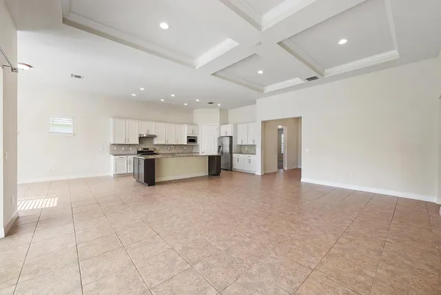 a view of kitchen with refrigerator and window