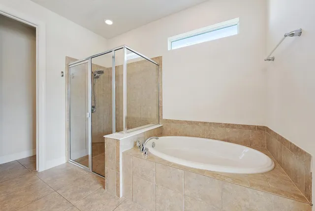 a bathroom with a bathtub and a shower
